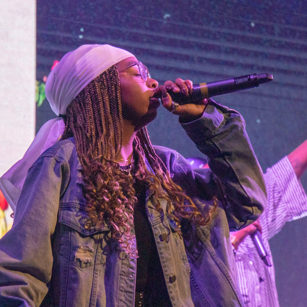 A black girl singing into a microphone