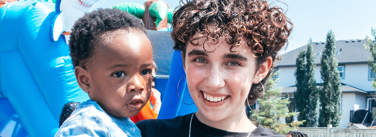 Little African boy in the arms of a caucasian girl