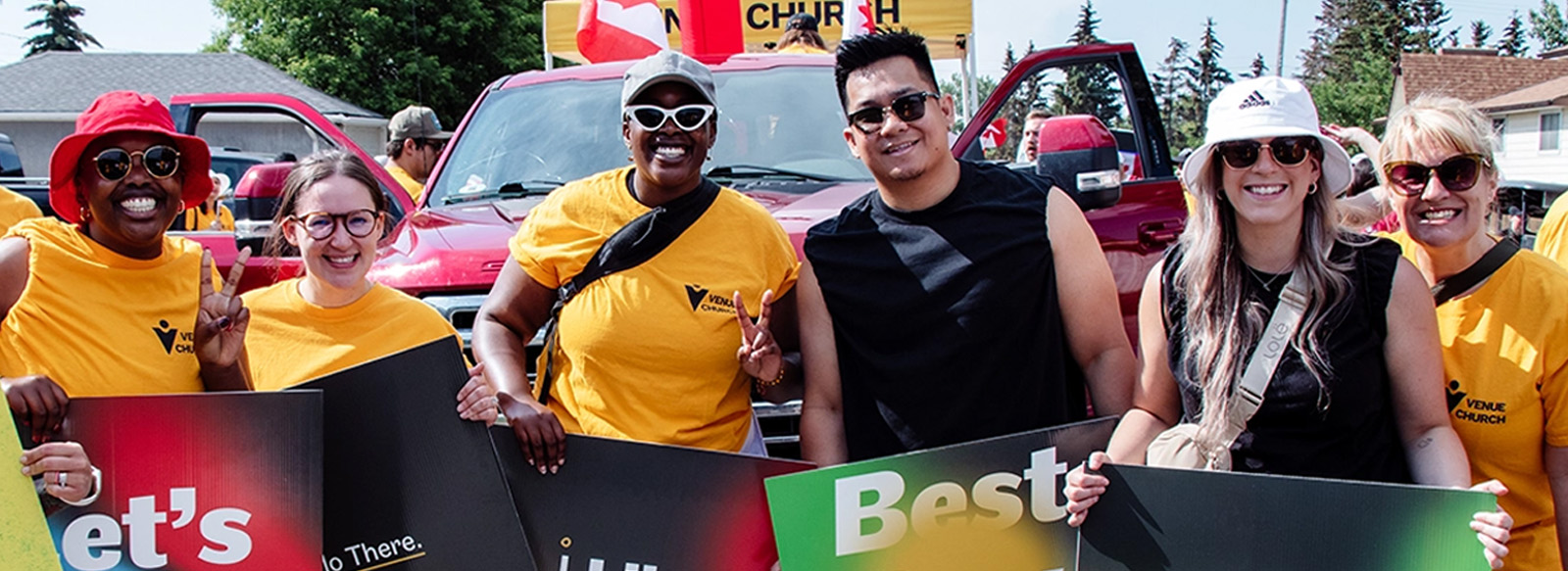 Multicultural groups of people smiling and holding signs that have various happy slogans